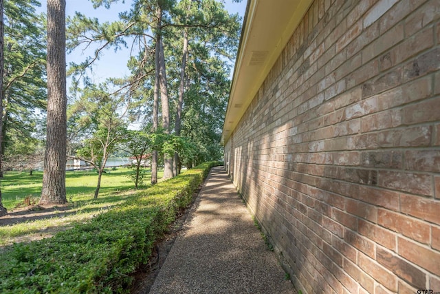 view of side of property with a lawn