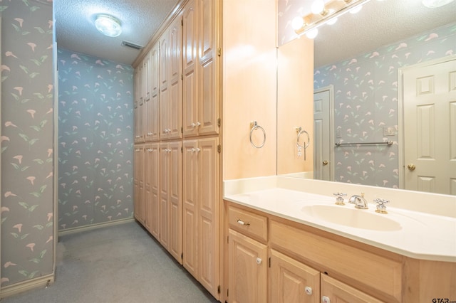 bathroom featuring vanity and a textured ceiling