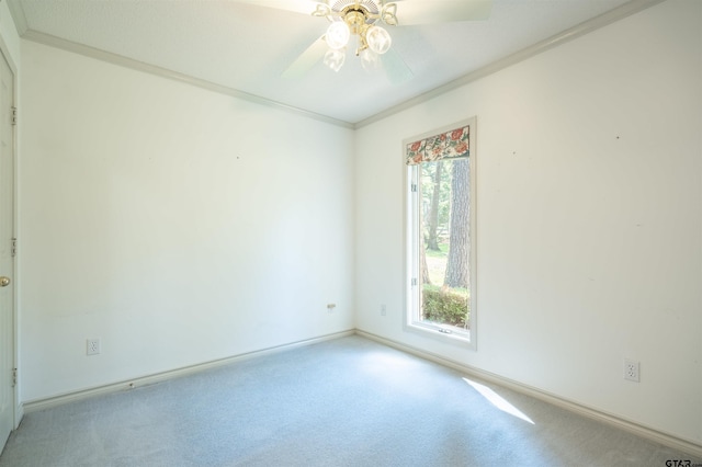 spare room with ornamental molding, light carpet, and ceiling fan