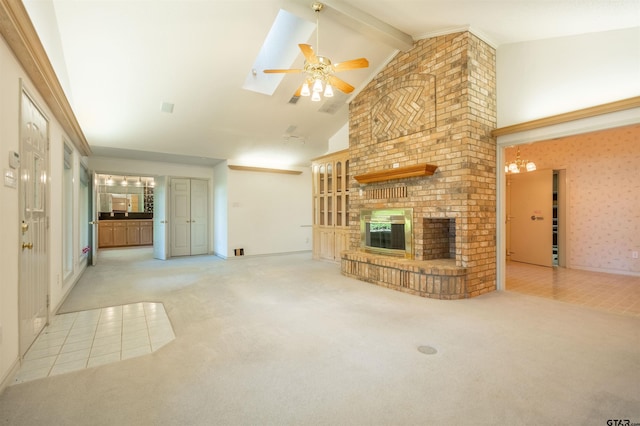 unfurnished living room featuring a brick fireplace, light colored carpet, ceiling fan, a skylight, and beam ceiling