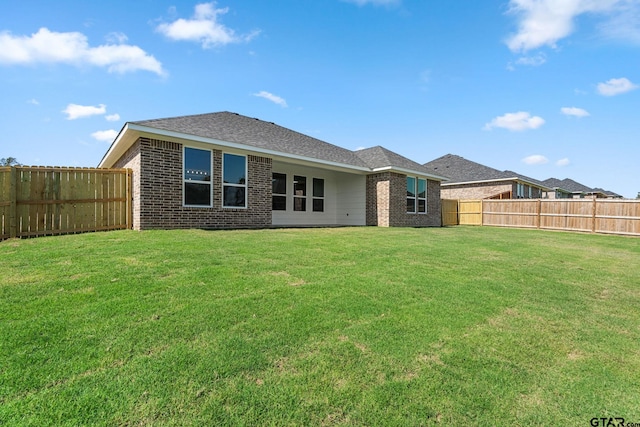 back of house with a lawn