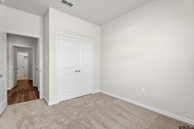 unfurnished bedroom featuring carpet and a closet