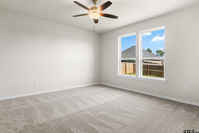 carpeted empty room featuring ceiling fan