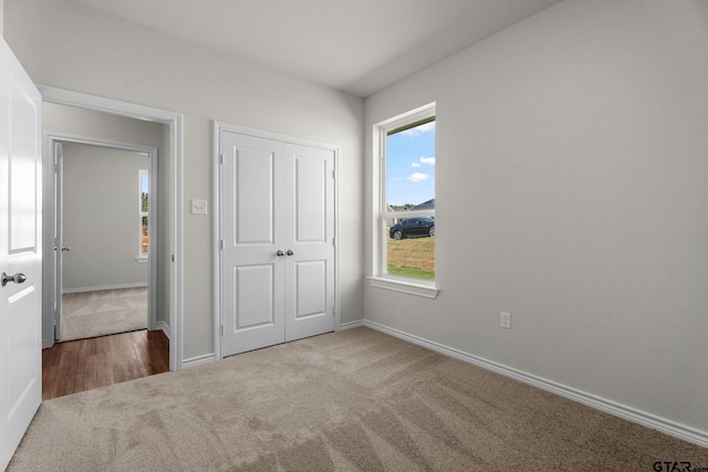 unfurnished bedroom with a closet and carpet floors