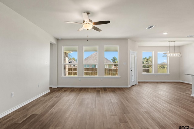 unfurnished living room with ceiling fan and hardwood / wood-style floors