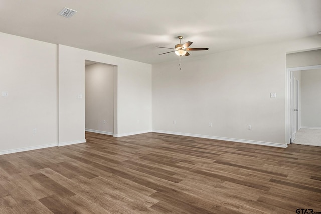 unfurnished room with dark hardwood / wood-style flooring and ceiling fan