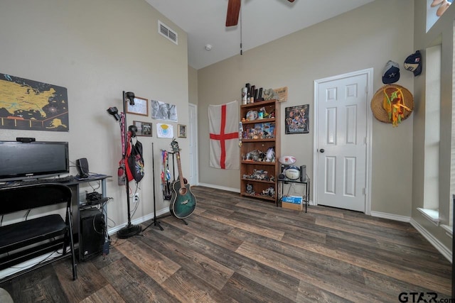 office area with ceiling fan, visible vents, baseboards, and dark wood finished floors