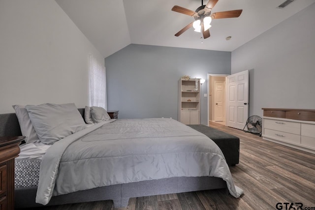 bedroom featuring ceiling fan, visible vents, vaulted ceiling, and wood finished floors