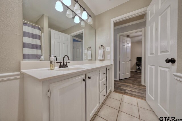 full bathroom with tile patterned flooring and vanity