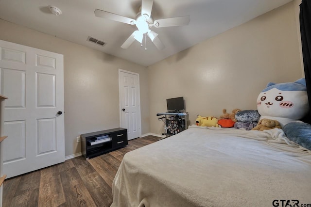 bedroom featuring ceiling fan, dark wood finished floors, visible vents, and baseboards