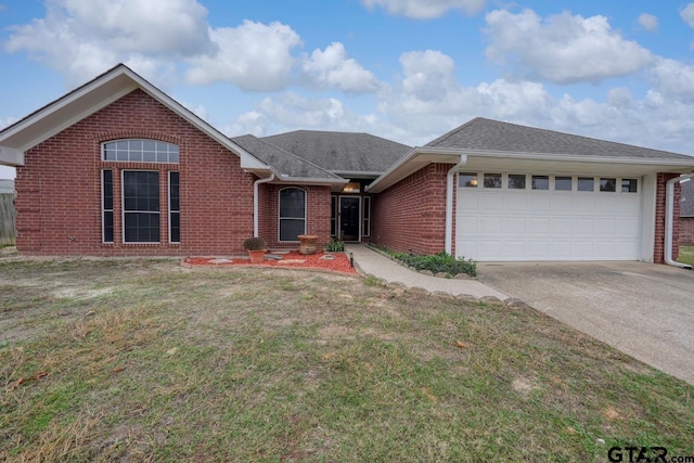 view of front of house with a front yard and a garage