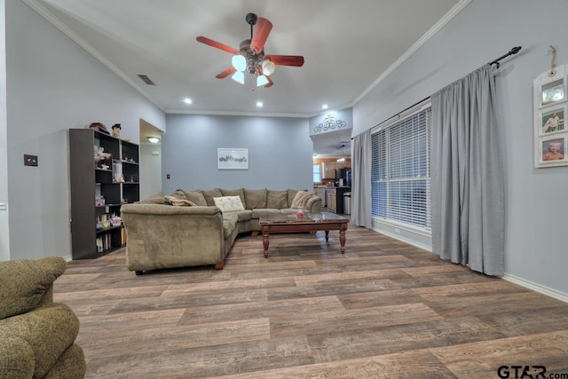 living area featuring visible vents, ornamental molding, wood finished floors, and recessed lighting