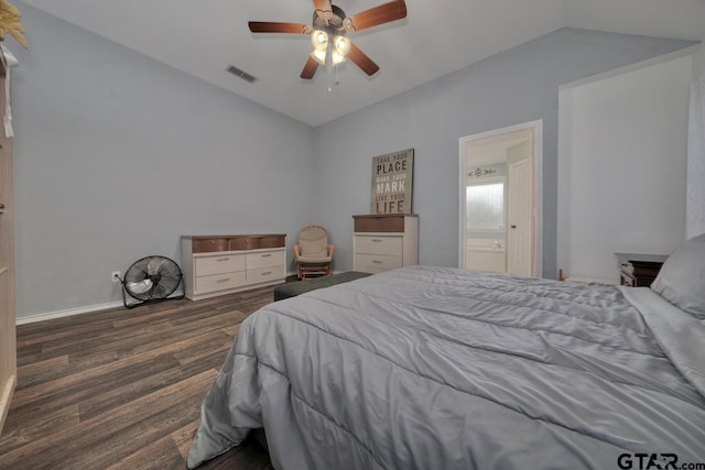 bedroom featuring lofted ceiling, connected bathroom, dark wood-type flooring, visible vents, and a ceiling fan