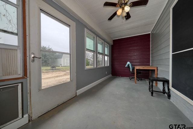 sunroom / solarium featuring ceiling fan