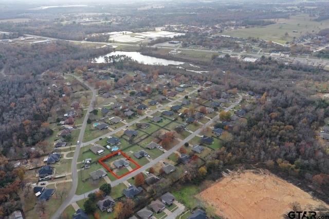 drone / aerial view featuring a water view and a residential view