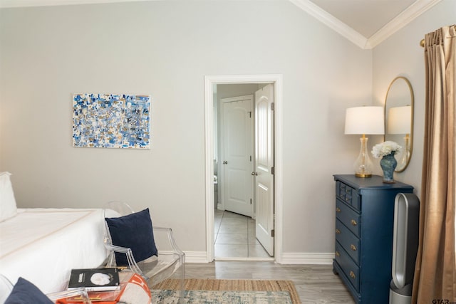 sitting room with vaulted ceiling, crown molding, and light hardwood / wood-style flooring