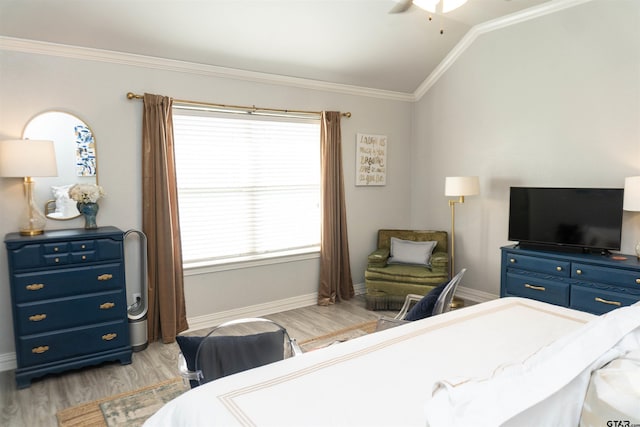 bedroom with crown molding, vaulted ceiling, ceiling fan, and light hardwood / wood-style flooring