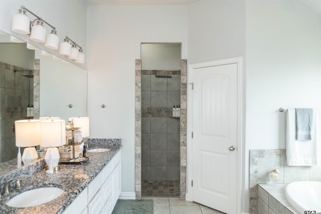 bathroom featuring vanity, plus walk in shower, and tile patterned flooring