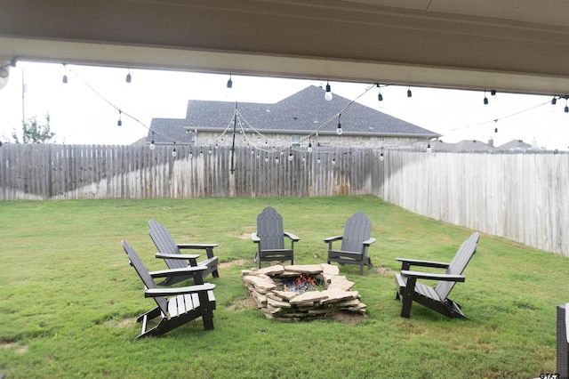 view of yard featuring an outdoor fire pit