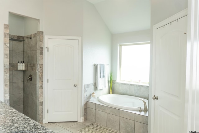 bathroom featuring lofted ceiling, tile patterned floors, and separate shower and tub