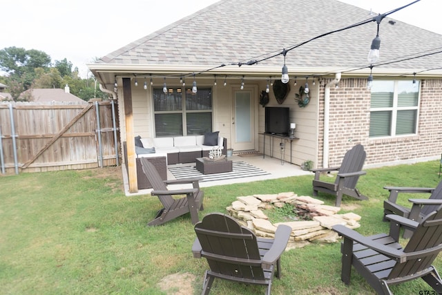 rear view of property featuring a lawn, an outdoor hangout area, and a patio area