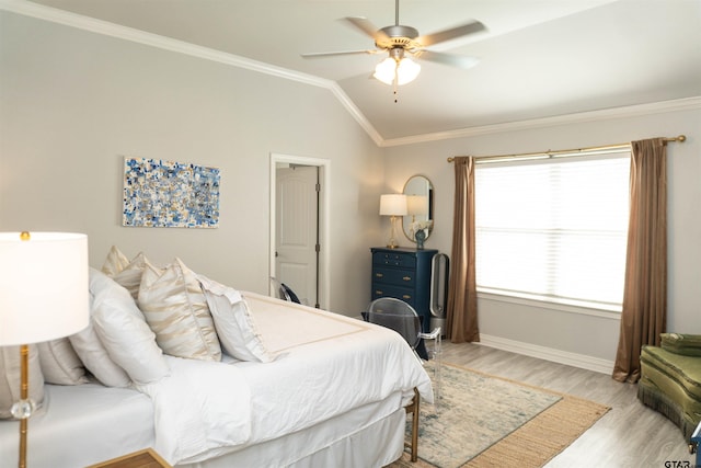 bedroom with ornamental molding, light hardwood / wood-style floors, vaulted ceiling, and ceiling fan