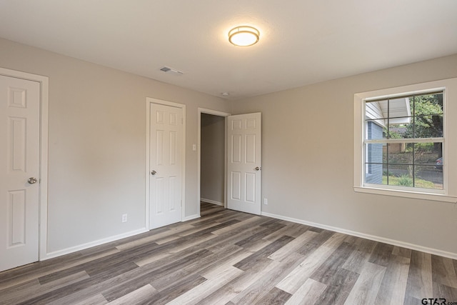 unfurnished bedroom featuring wood-type flooring