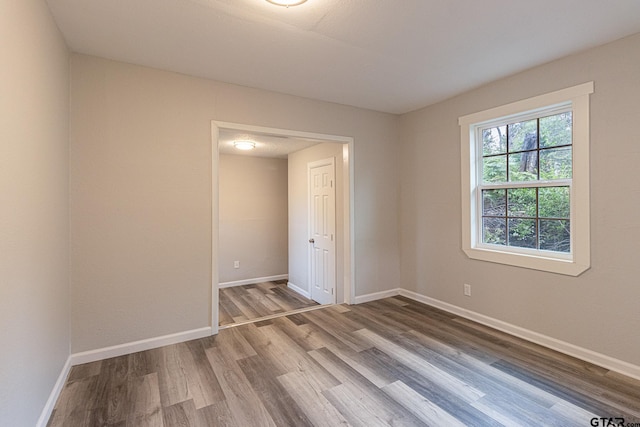 unfurnished room featuring hardwood / wood-style flooring