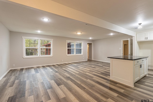 unfurnished living room featuring dark wood-type flooring