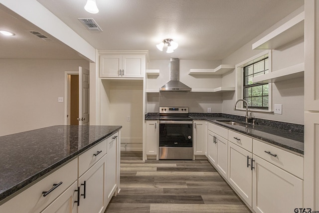 kitchen featuring stainless steel electric range, dark hardwood / wood-style flooring, sink, white cabinets, and wall chimney exhaust hood