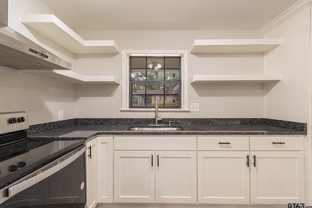 kitchen with sink, dark stone counters, wall chimney exhaust hood, stainless steel electric stove, and white cabinets