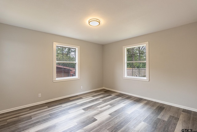 empty room featuring hardwood / wood-style flooring and a healthy amount of sunlight