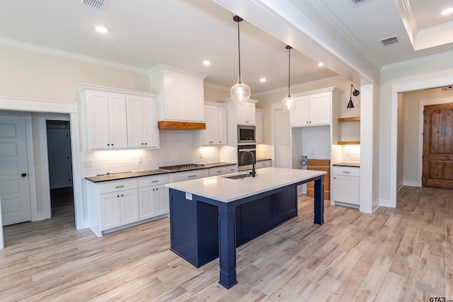 kitchen with tasteful backsplash, gas cooktop, oven, stainless steel microwave, and visible vents