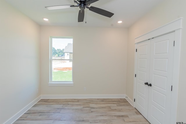 spare room featuring baseboards, a ceiling fan, light wood finished floors, and recessed lighting
