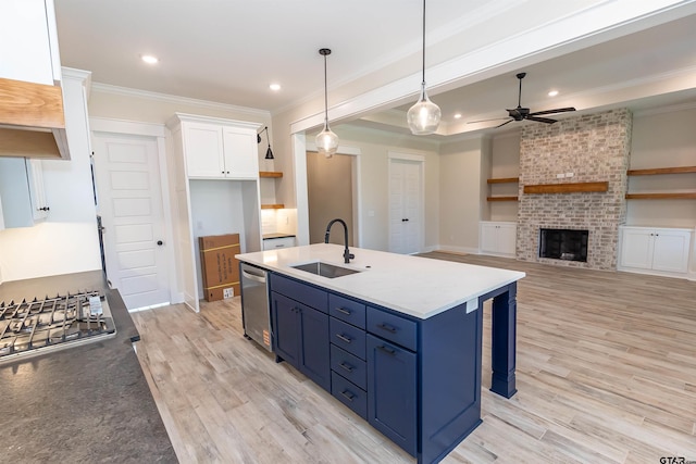 kitchen featuring crown molding, a sink, ceiling fan, appliances with stainless steel finishes, and white cabinetry