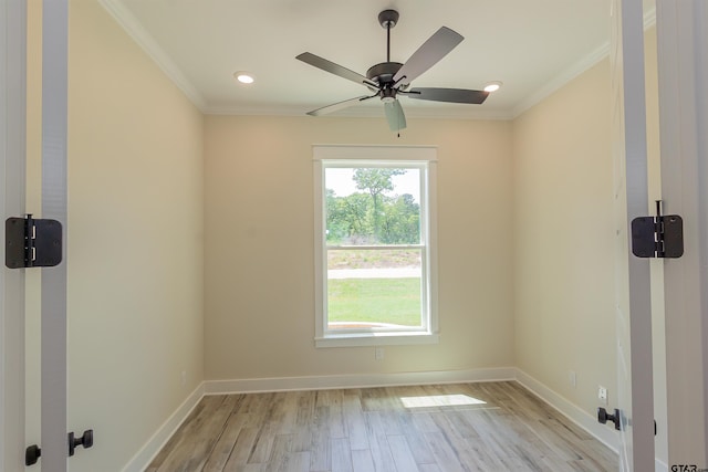 spare room with light wood finished floors, baseboards, and ornamental molding