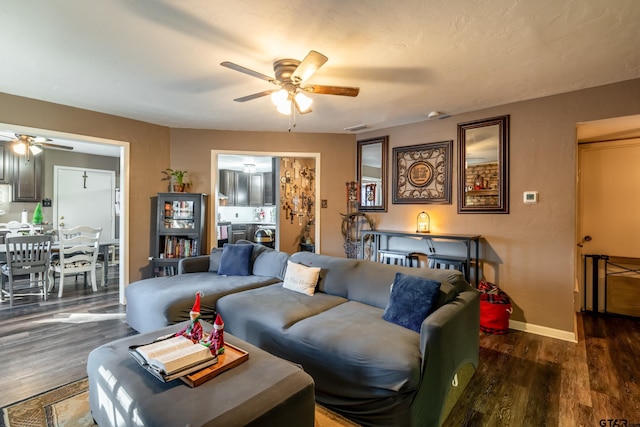 living room featuring dark hardwood / wood-style flooring and ceiling fan