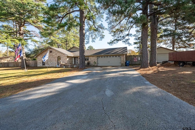 ranch-style home with a garage and a front yard