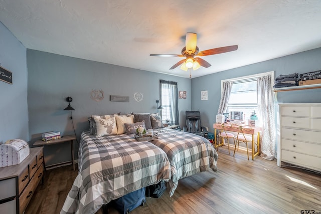 bedroom featuring hardwood / wood-style floors and ceiling fan