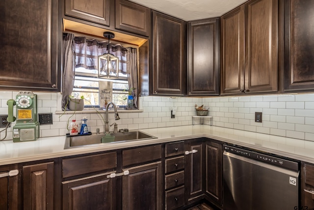 kitchen featuring backsplash, stainless steel dishwasher, dark brown cabinetry, and sink