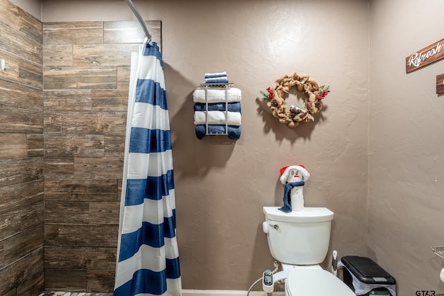 bathroom featuring toilet and walk in shower