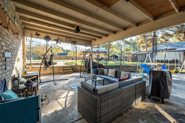 view of patio / terrace with area for grilling, an outdoor living space, and a trampoline