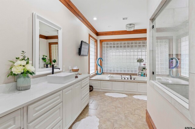 bathroom with crown molding, a bathtub, and vanity