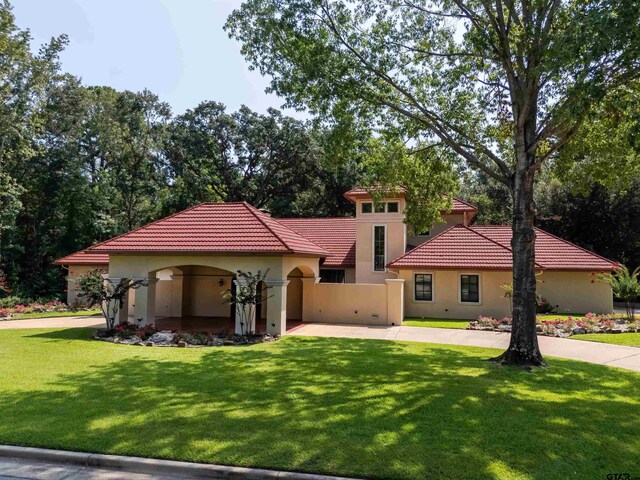 mediterranean / spanish-style home featuring a front lawn