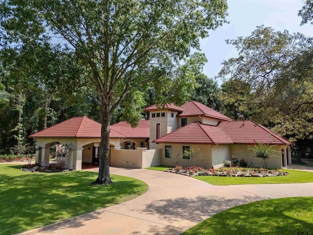 mediterranean / spanish house featuring a front lawn