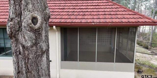 view of side of home with a sunroom