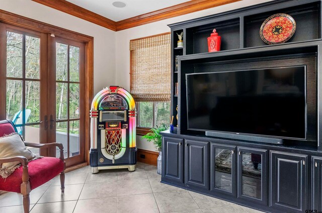 living room with french doors, light tile patterned floors, and ornamental molding