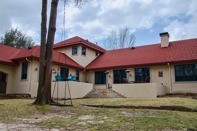 rear view of house with a lawn