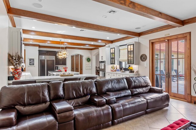 tiled living room featuring french doors, a notable chandelier, and beam ceiling