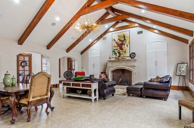 living room with beamed ceiling, high vaulted ceiling, and a chandelier